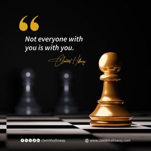 Golden chess pawn on a chessboard with a motivational quote: “Not everyone with you is with you” by Clement H. Holloway.